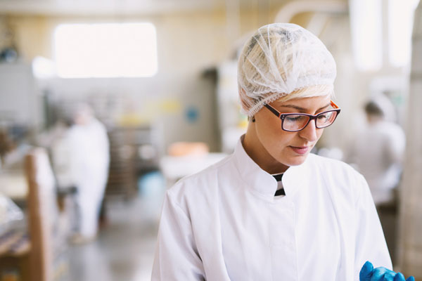 Lady preparing food in factory